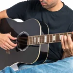 handsome-man-with-guitar-white-background-1-scaled-_1_ Clases guitarra acústica